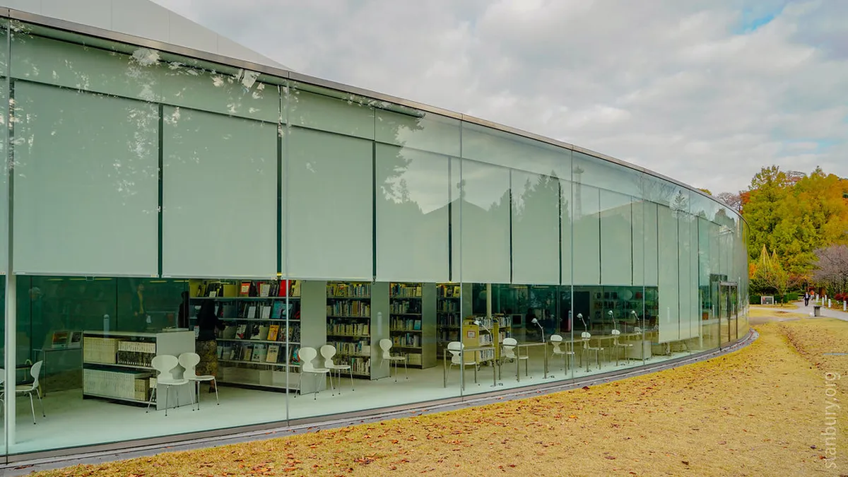 The circular glass exterior of SANAA's 21st Century Museum of Contemporary Art surrounded by open public space in Kanazawa
