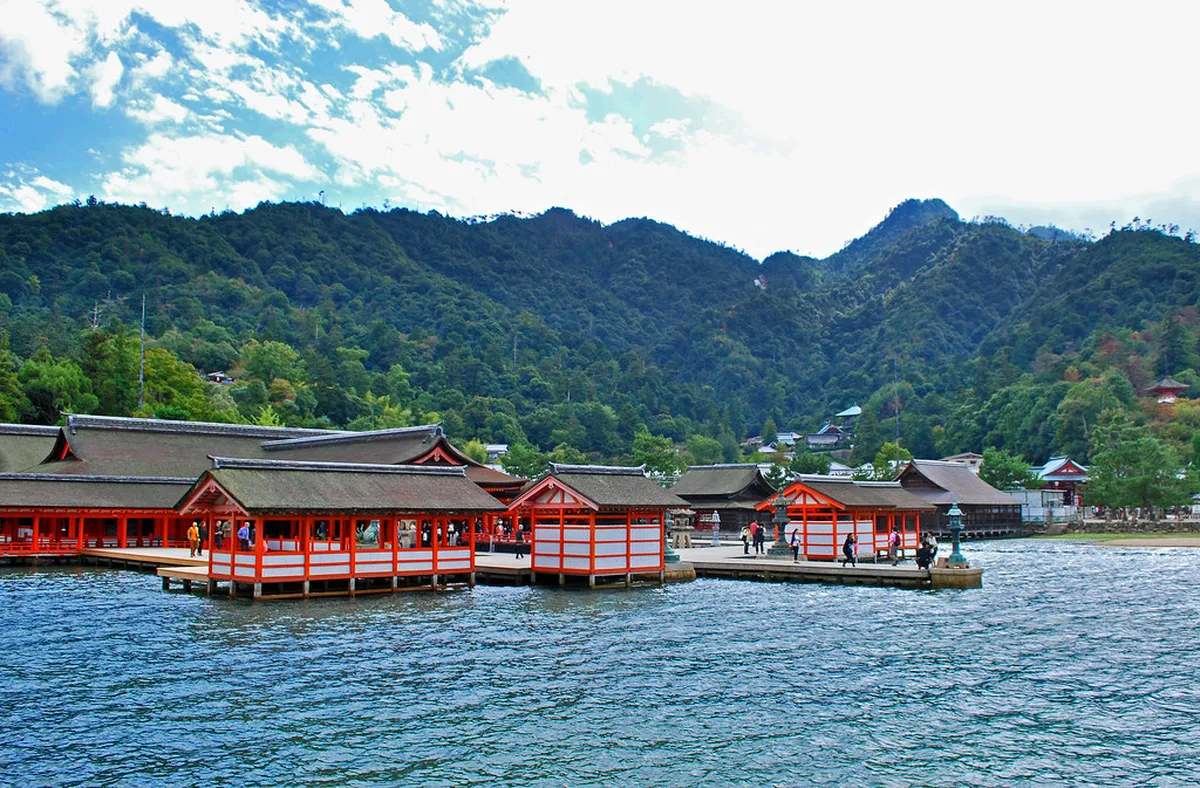 Itsukushima Shrine gate and red torii rising from the calm sea at Miyajima Island near Hiroshima, Japan