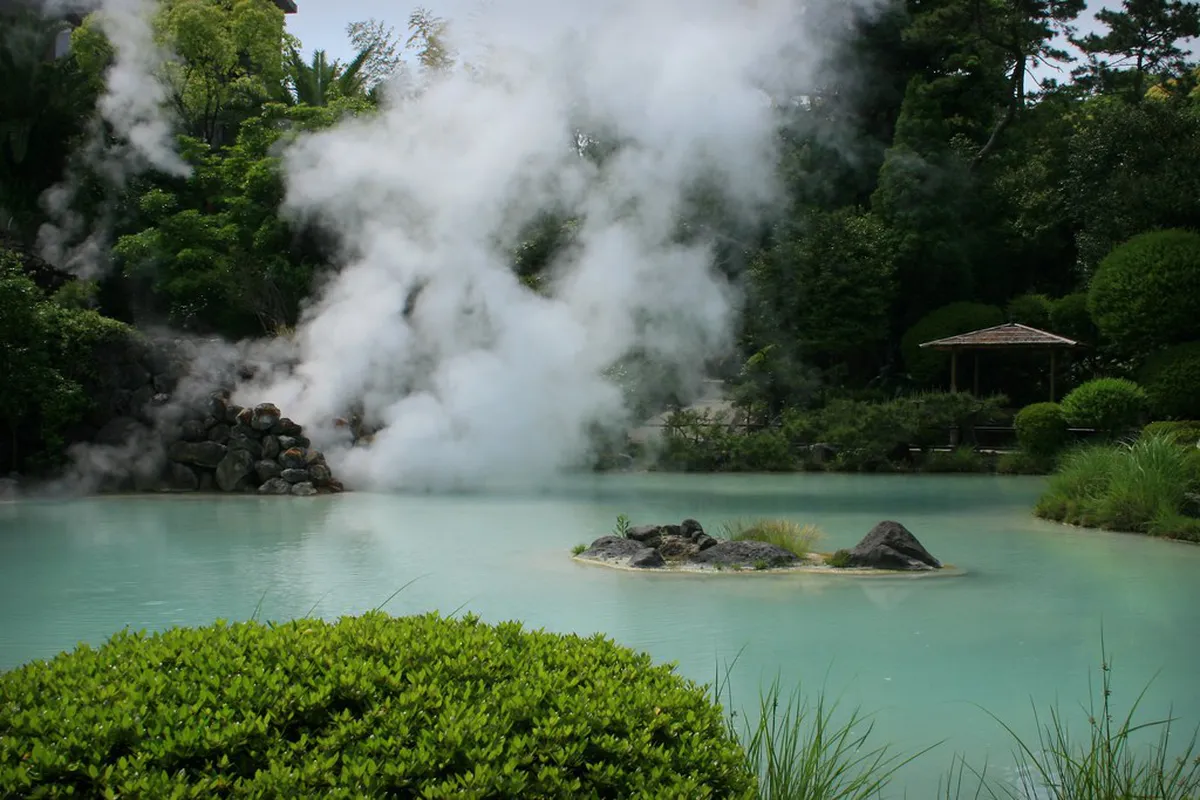 Umi Jigoku cobalt-blue Sea Hell steaming pool surrounded by tropical gardens in Beppu, Japan
