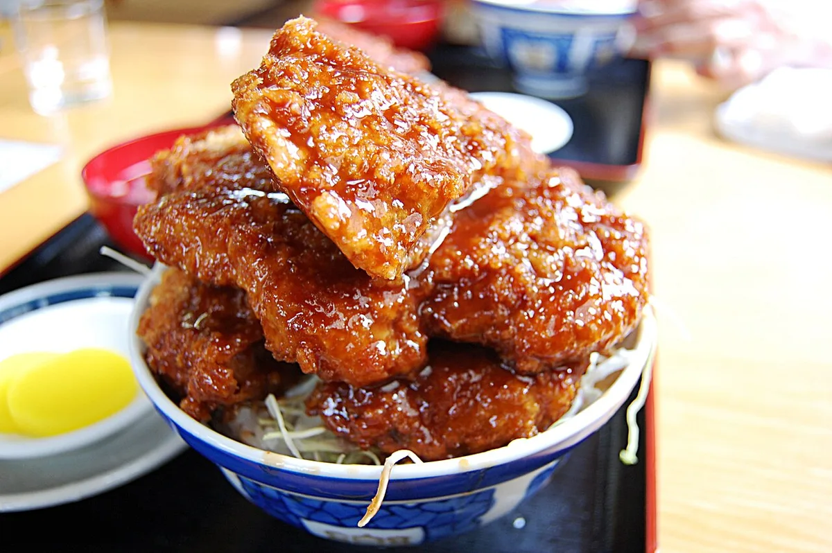 Aizu sauce katsudon with glazed pork cutlets over cabbage and rice, Japan — 1