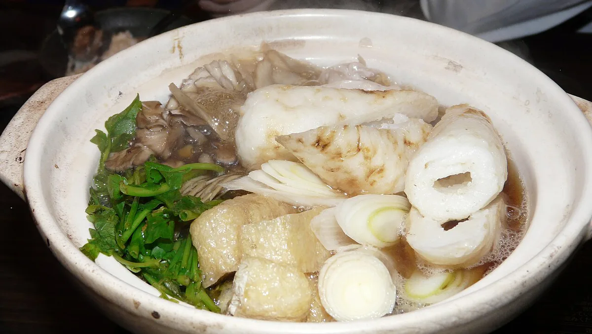 Assorted Akita regional dishes including kiritanpo and hatahata on a table, Japan — 1
