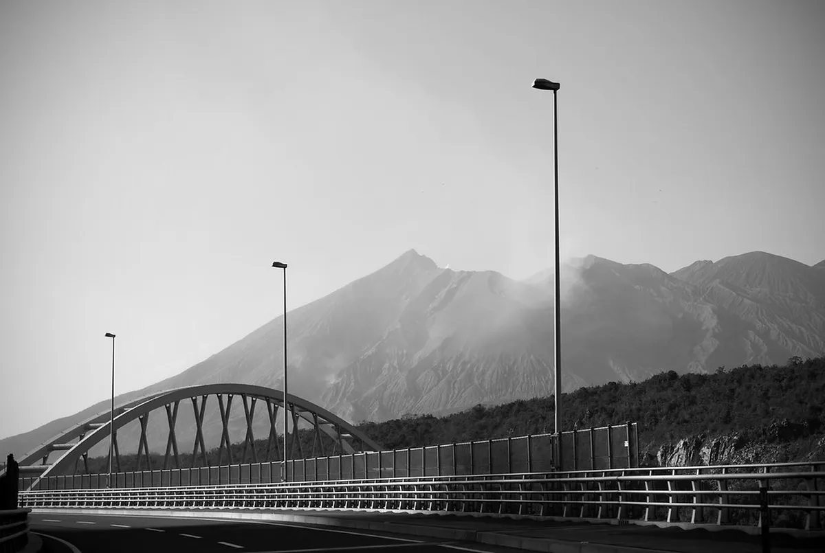 Sakurajima volcano erupting with a dark ash cloud rising over Kagoshima Bay in southern Japan