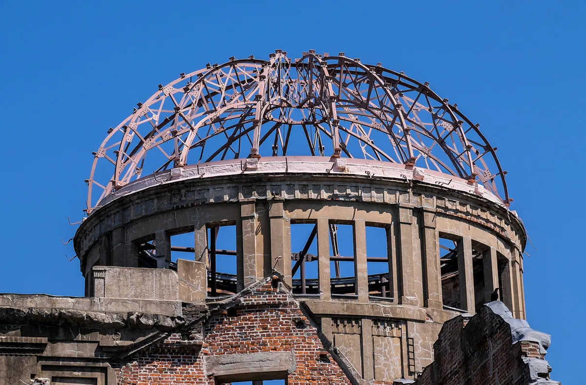 The Atomic Bomb Dome skeletal ruins preserved beside the Motoyasu River in Hiroshima Peace Memorial Park, Japan