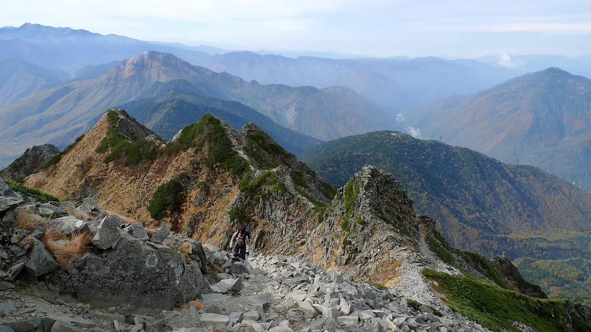 Hotaka area in Azumino, Nagano with the Northern Japan Alps rising behind rural farmland and clear skies