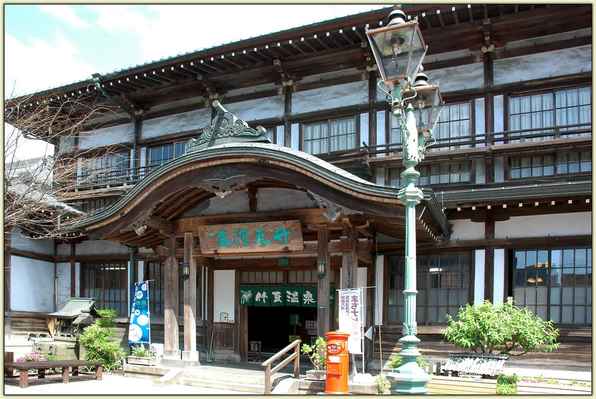 Traditional wooden bathhouse exterior of Takegawara Onsen in central Beppu Japan