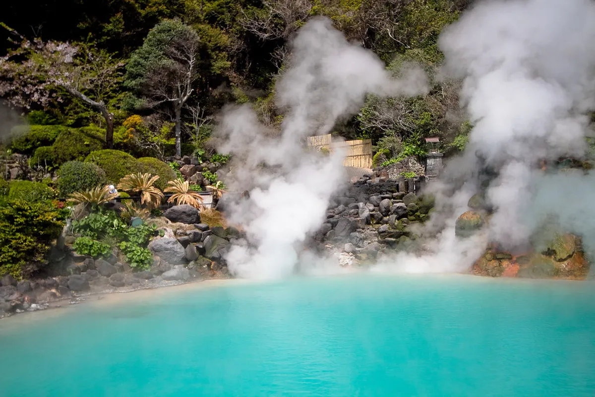 Bright blue steaming pool at the Beppu Jigoku hells in Japan with rising volcanic steam