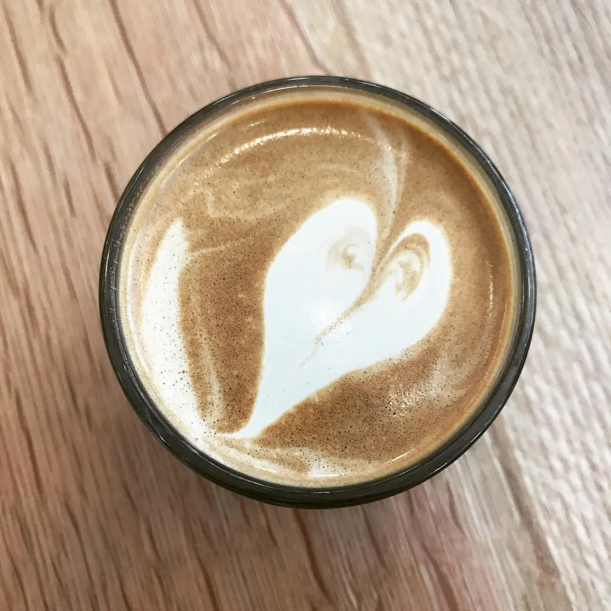 Specialty coffee latte with delicate foam art at a Kanazawa artisan cafe