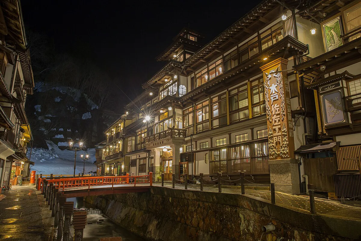 Snow-dusted onsen town street lit by gas lamps at dusk, Japan — 1