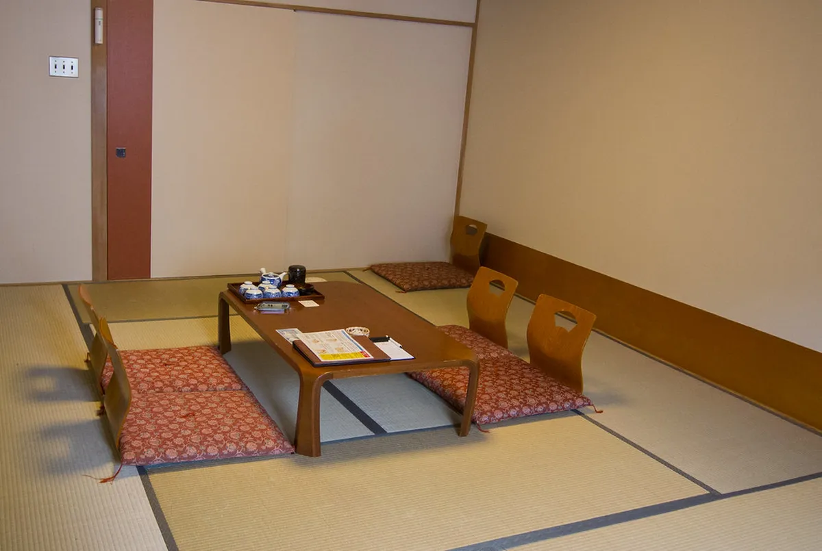 Traditional tatami room in a Japanese ryokan with futon bedding and shoji screens