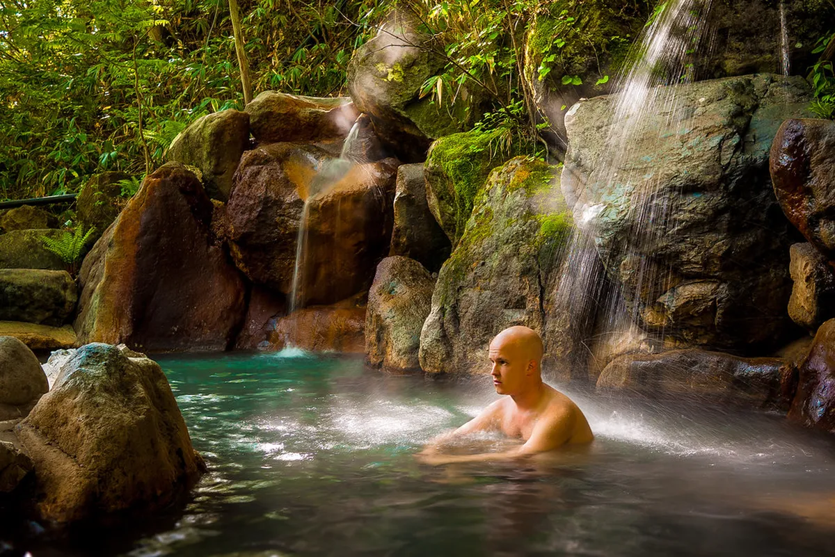Outdoor hot spring rotenburo bath surrounded by Takayama mountain scenery in Gifu Prefecture Japan