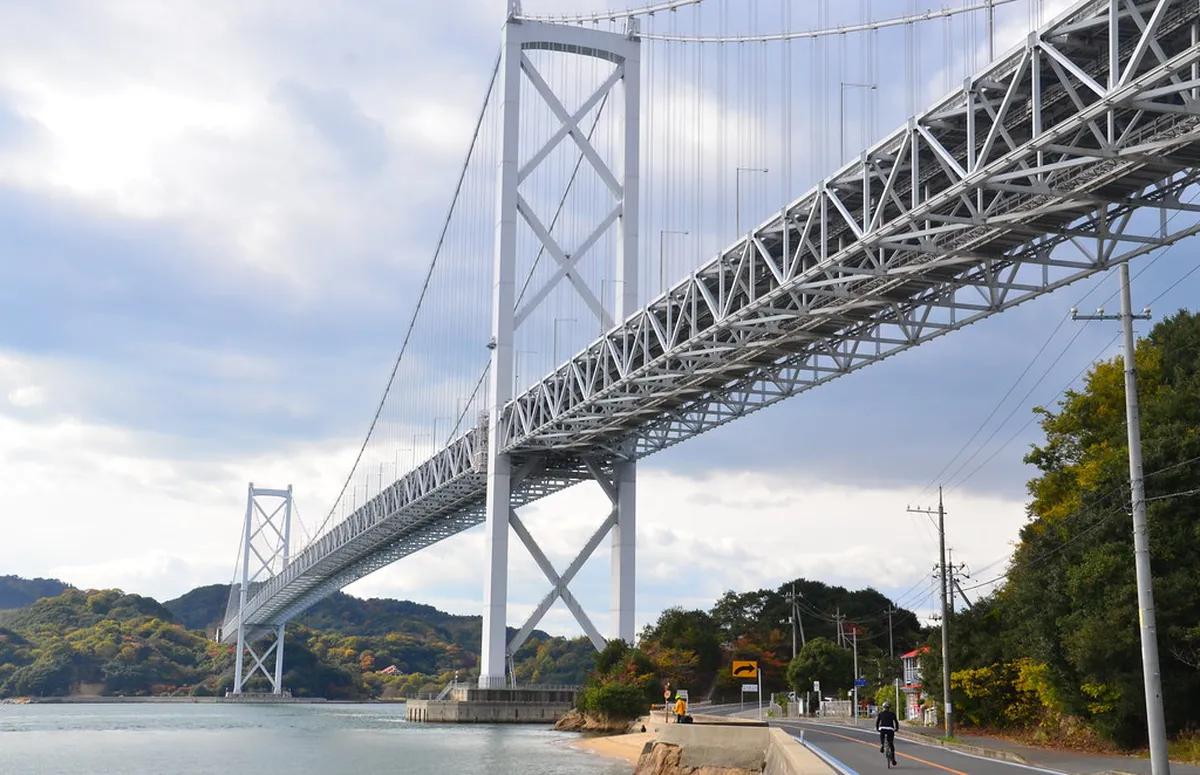 Cyclists riding the Shimanami Kaido bridge route across the Seto Inland Sea islands near Hiroshima Japan