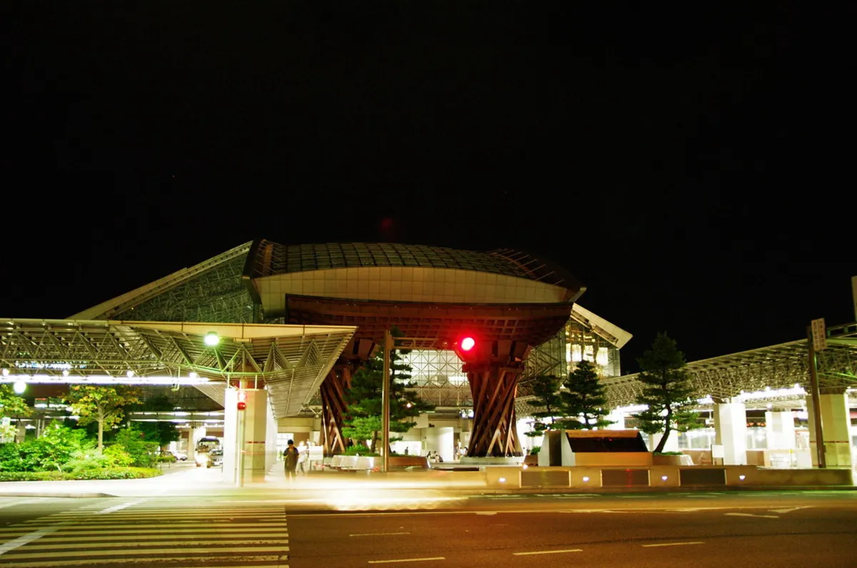 Kanazawa Station illuminated at night with the iconic Tsuzumi-mon drum gate