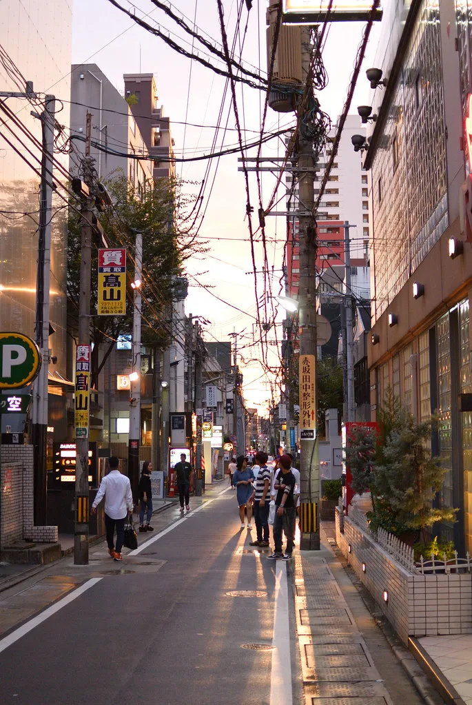 Tenjin area street in central Fukuoka with shops and pedestrians