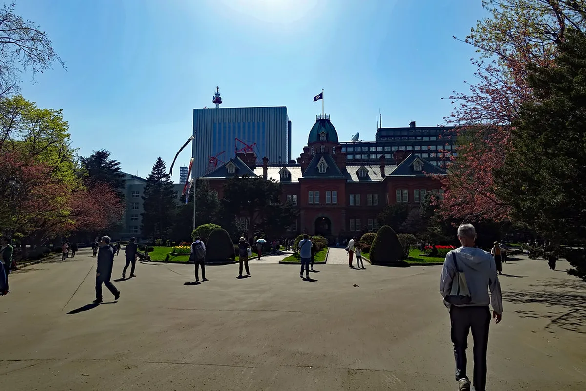 Seasonal gardens surrounding the Akarenga red brick building in central Sapporo with trees and lawns