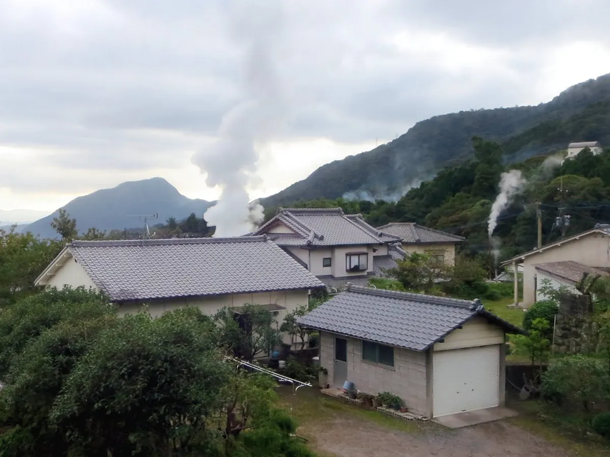Steaming outdoor hot spring pools at the famous Beppu onsen district with natural geothermal mist rising in Japan