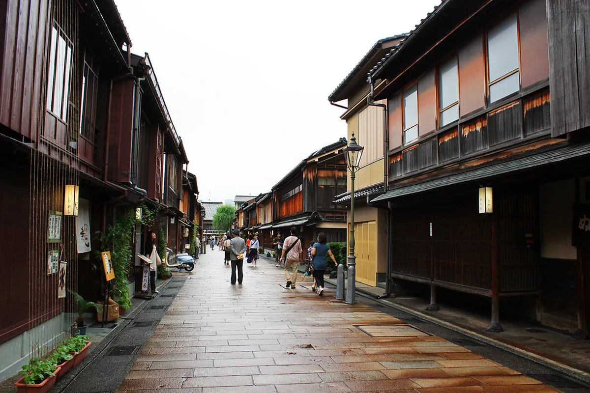 Cobblestone street lined with traditional wooden lattice teahouses in Higashi Chaya district, Kanazawa