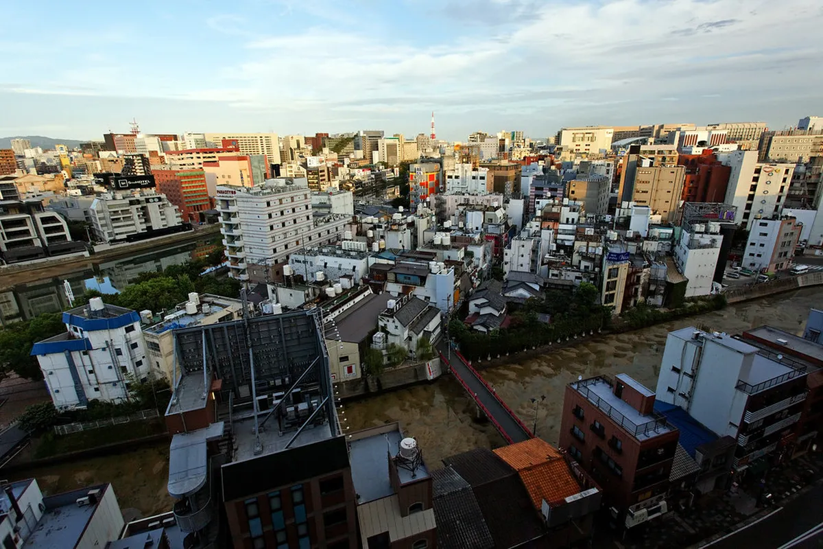 Canal City Hakata's distinctive curved architecture with canal water features and colorful shopfronts in Fukuoka Japan