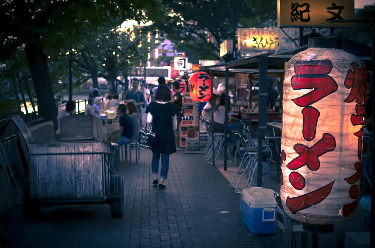 Nakasu yatai food stalls lit up along the riverside in Fukuoka on a warm summer evening