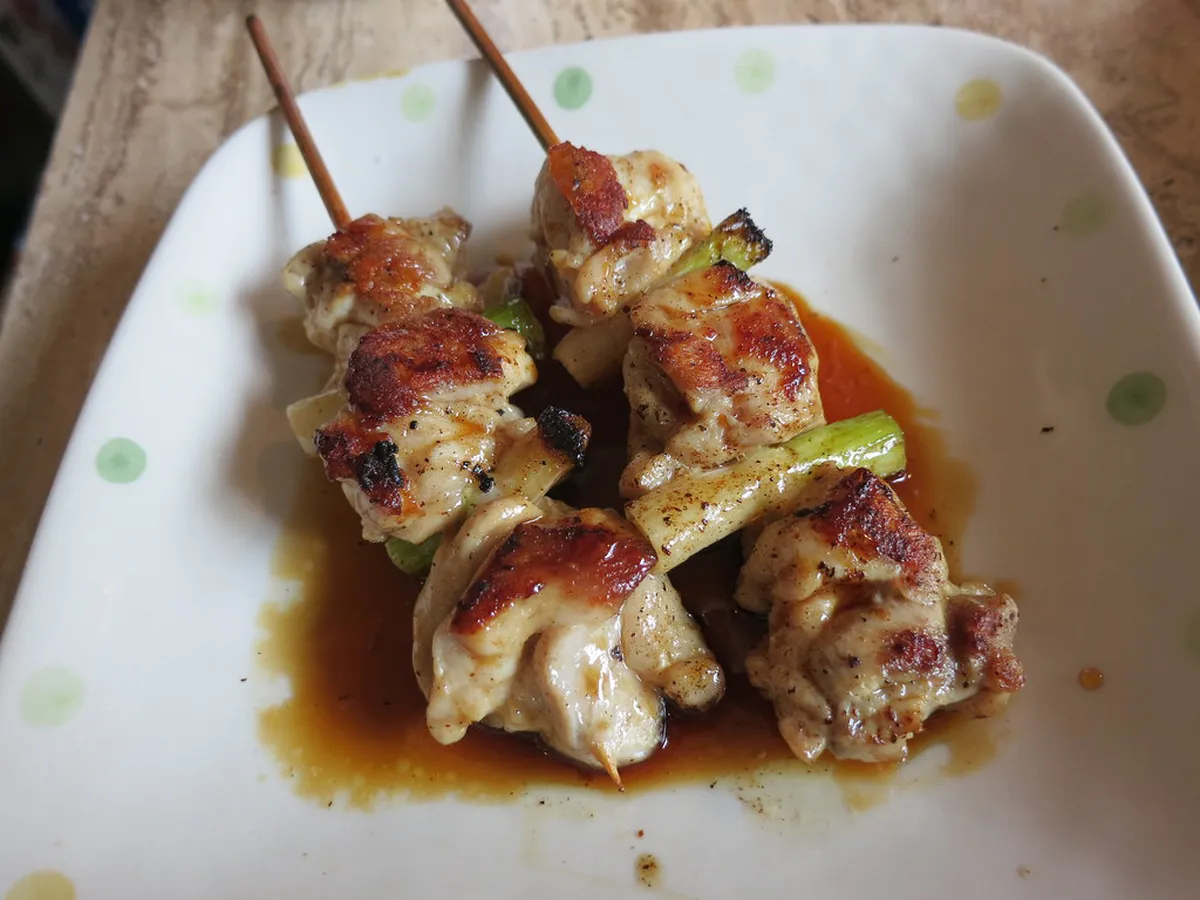 Yakitori grilled chicken skewers over charcoal at a Japanese street food stall — a summer staple in Fukuoka