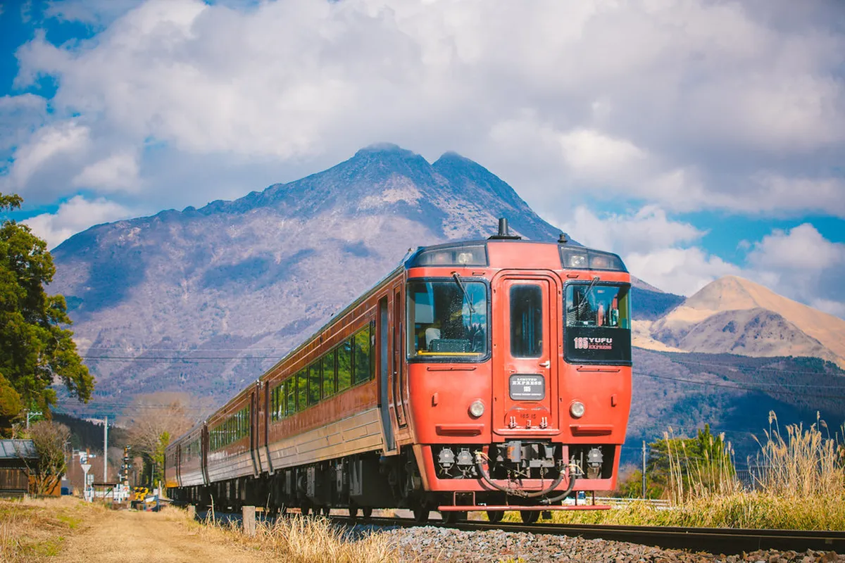 Mount Yufu twin peaks rising above Yufuin valley in Oita Prefecture — visible from the scenic train approach