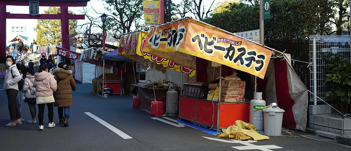 Row of illuminated yatai food stalls along the Naka River at night, Japan — 1