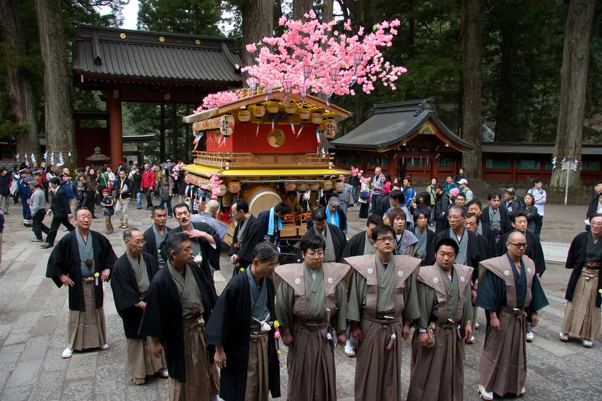 Futarasan Shrine Yayoi Matsuri festival procession with ornate floats through Nikko, Japan