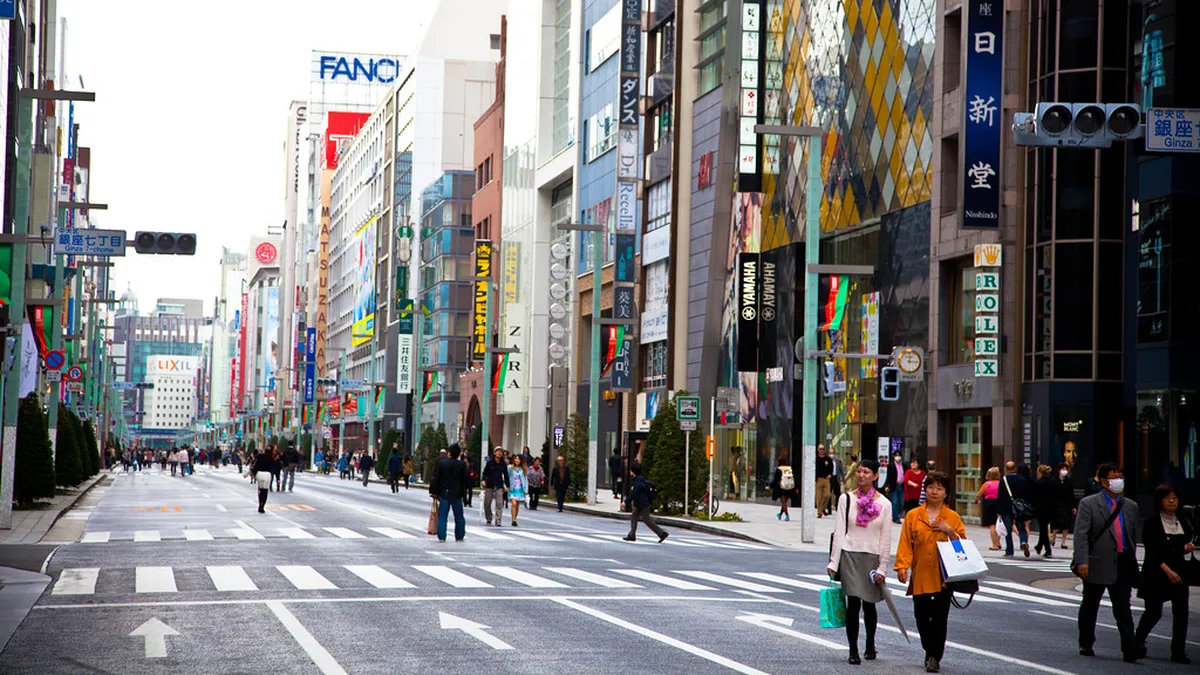 Chuo-dori main street in Ginza lined with luxury brand flagships and the Wako clock tower in central Tokyo Japan