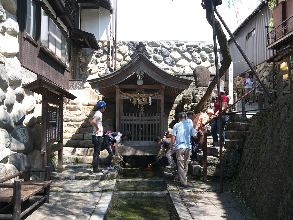 Local sake poured beside spring water in Gujo Hachiman, Japan — 2