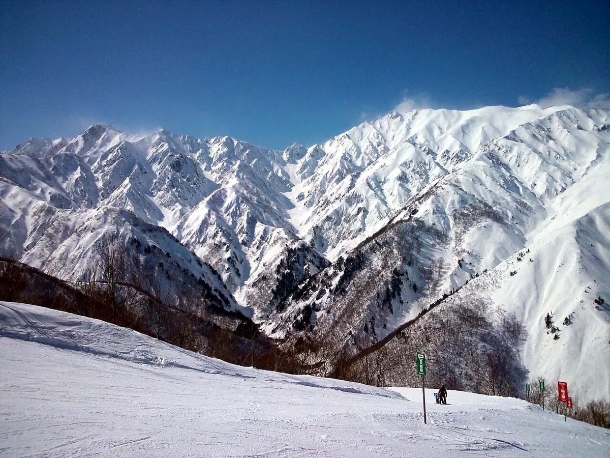Skiers descending a snowy run at Happo-One in Hakuba Valley, Japan — 1