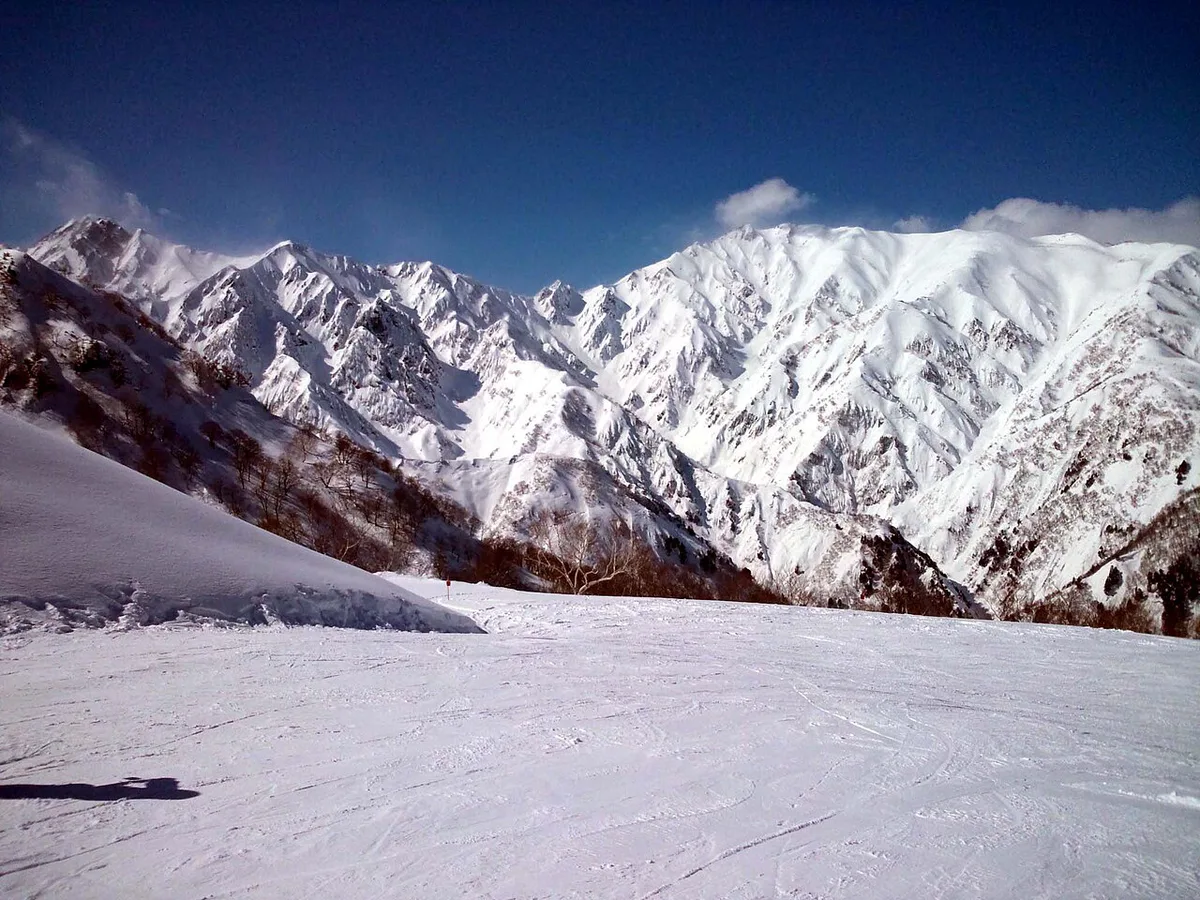 Skiers descending a snowy run at Happo-One in Hakuba Valley, Japan — 2