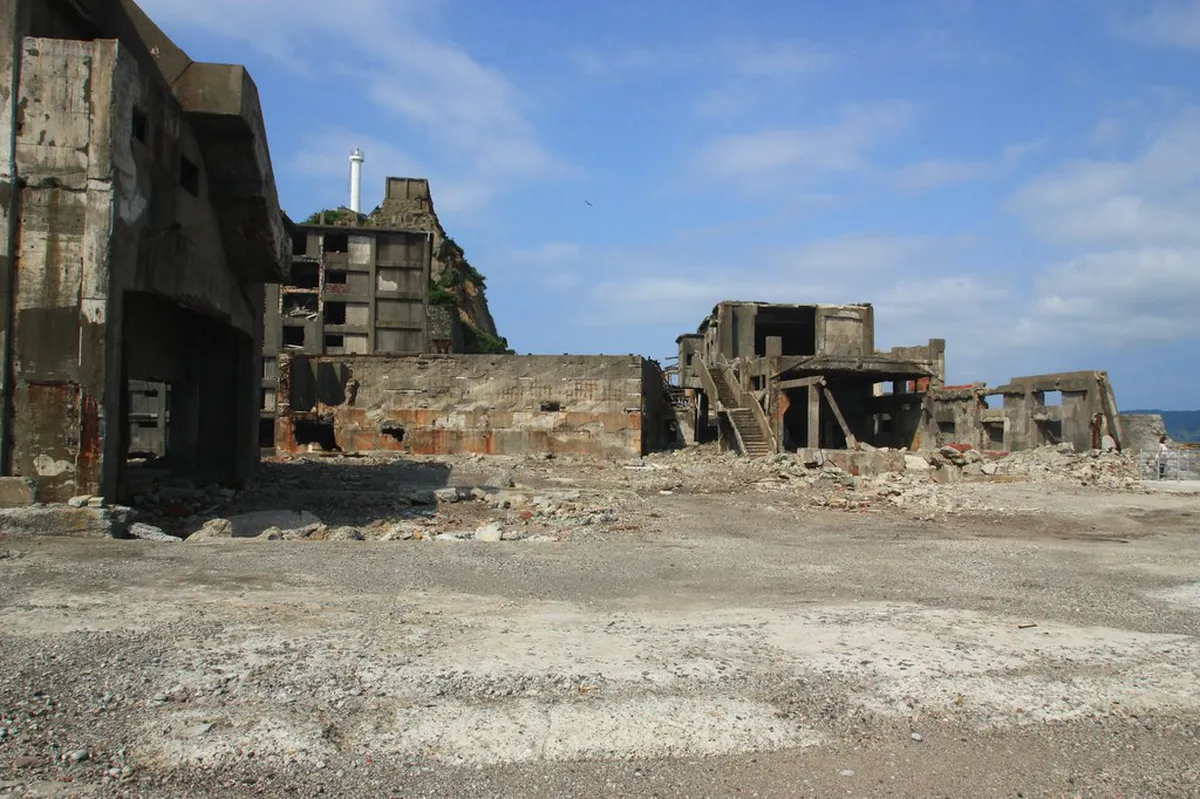 Hashima Island Gunkanjima seen from the water with its towering concrete apartment blocks rising from the East China Sea, Nagasaki