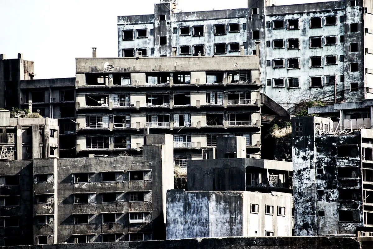 Aerial view of Hashima Island (Gunkanjima) off Nagasaki, Japan, showing the dense concrete ruins and sea walls of the abandoned coal mining settlement