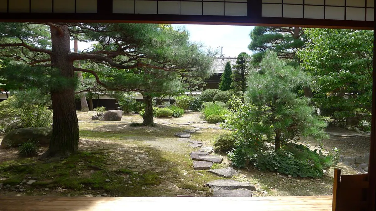 Hillside garden courtyard at the Hida Takayama Museum of Art with seasonal plantings and mountain views in Gifu Japan