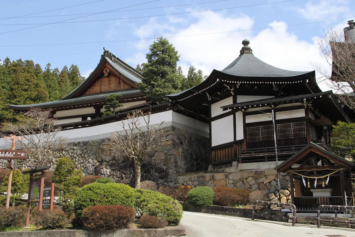 Historic temple gate and stone lantern path on the Higashiyama Walking Course through Takayama's eastern temple district