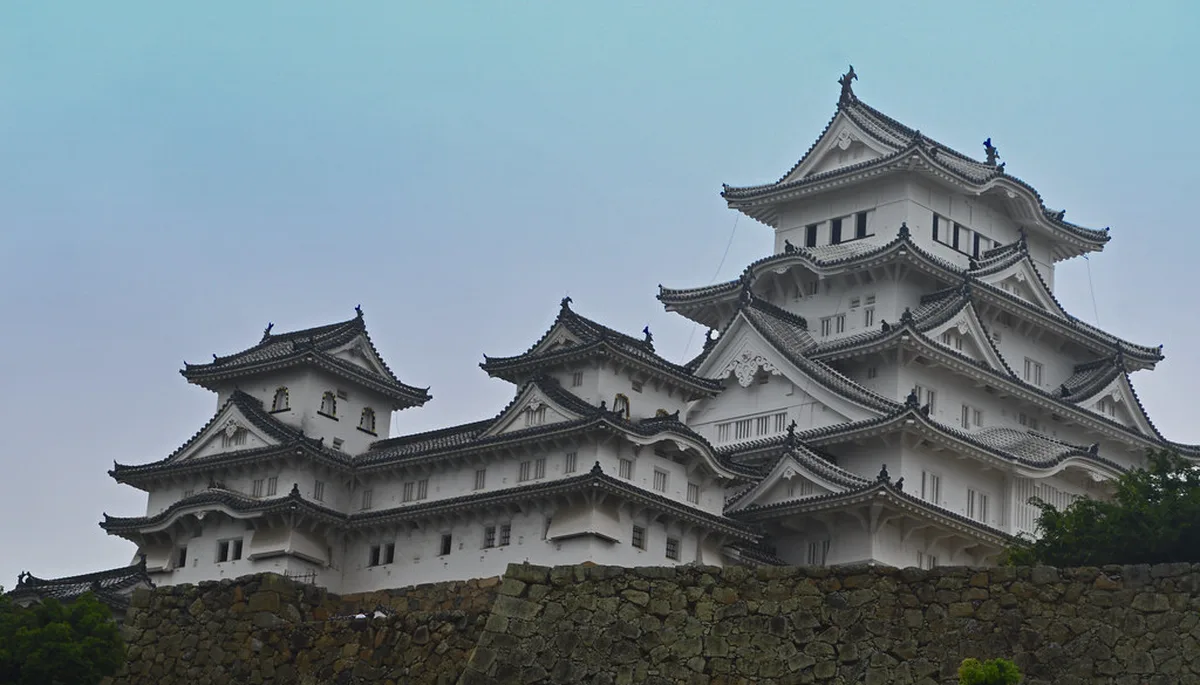 Himeji Castle's white keep rising above the stone ramparts in Himeji