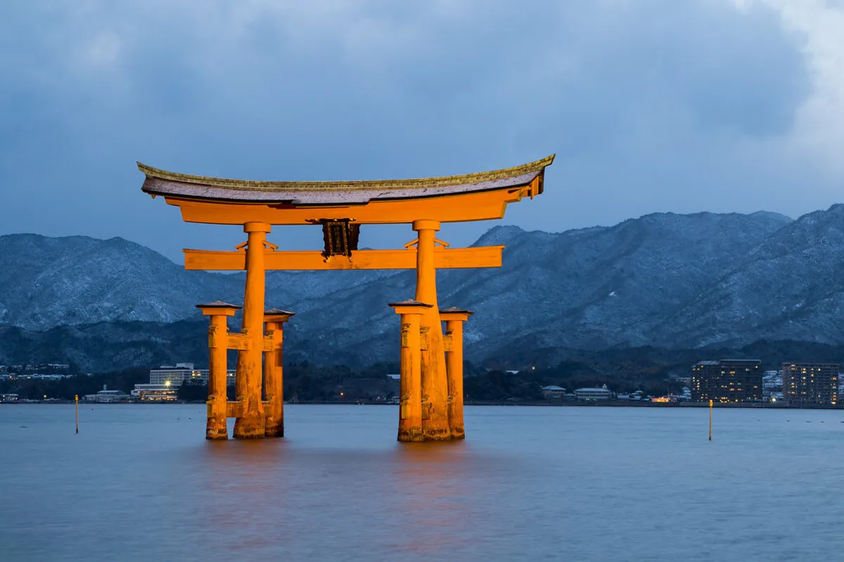Miyajima Island floating torii gate of Itsukushima Shrine rising from the sea at high tide in Japan