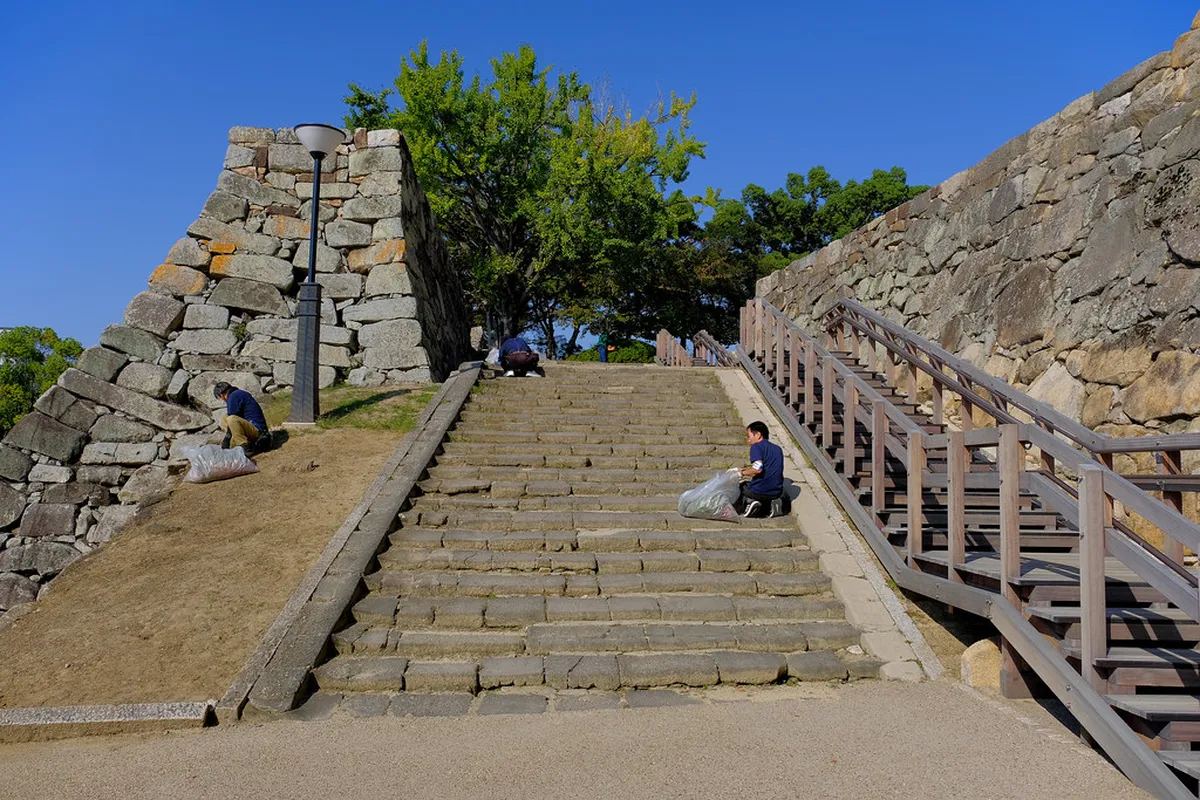 Hiroshima Castle five-story keep rising above the Edo-period stone moat walls, Hiroshima, Japan