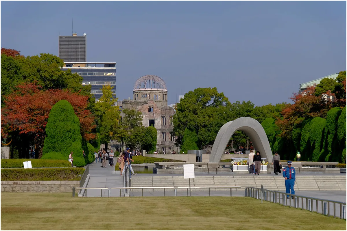Hiroshima Peace Memorial Park with the A-Bomb Dome framed through the Cenotaph arch reflecting in the Motoyasu River, Japan