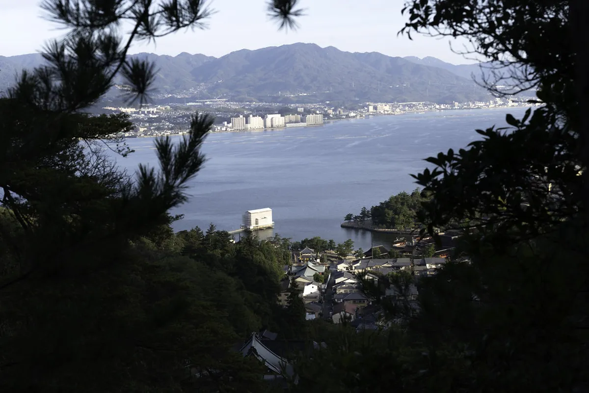 Hikers ascending Mount Misen trail on Miyajima island with views of the Seto Inland Sea, Hiroshima Japan