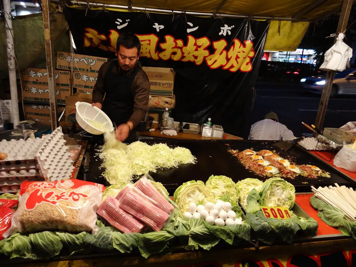 Japanese festival food stalls lit up at night along the Hiroshima Tokasan arcade, Japan