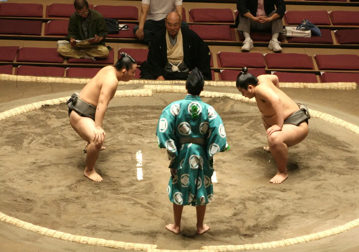 Sumo wrestlers walking in traditional silk kimono before a tournament at a venue in Fukuoka, Japan