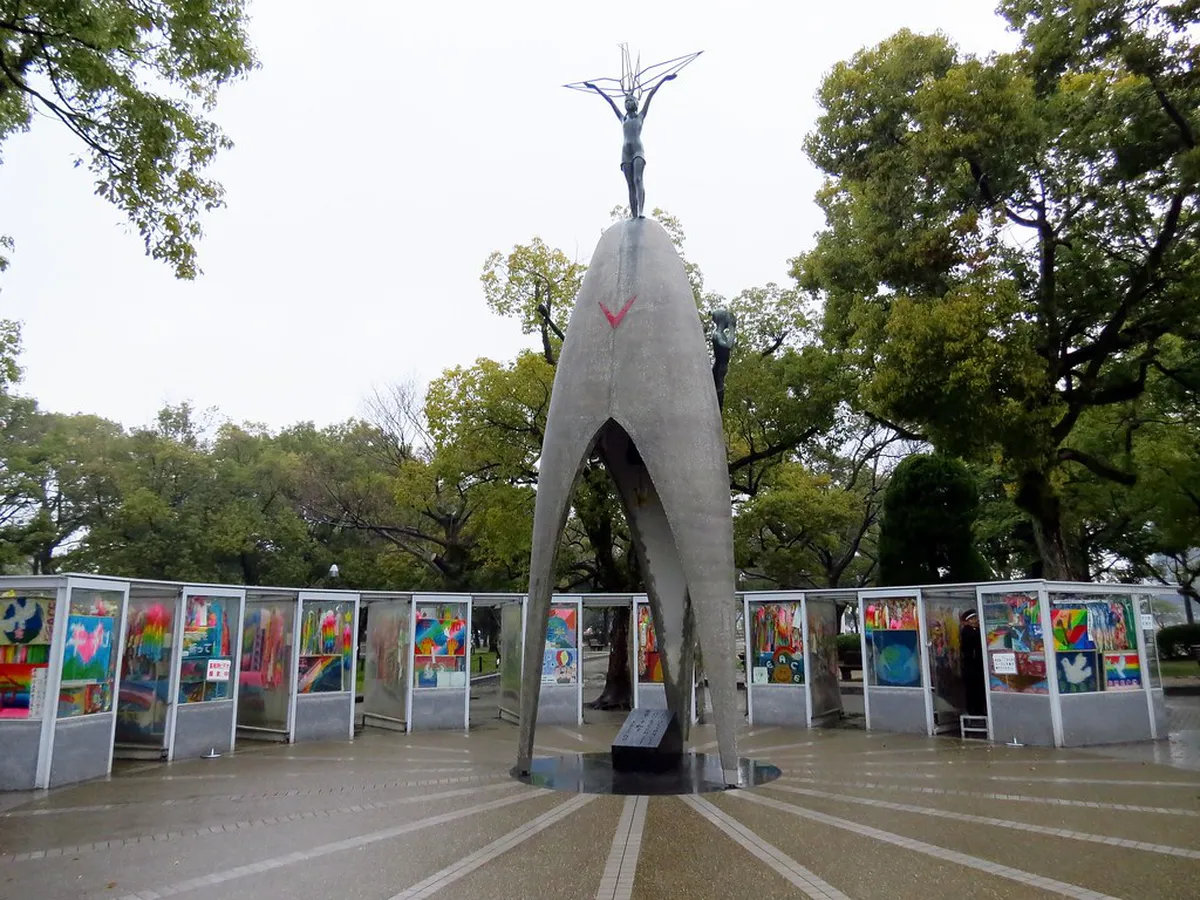 Children's Peace Monument in Hiroshima Peace Memorial Park surrounded by glass cases of donated paper cranes, Japan