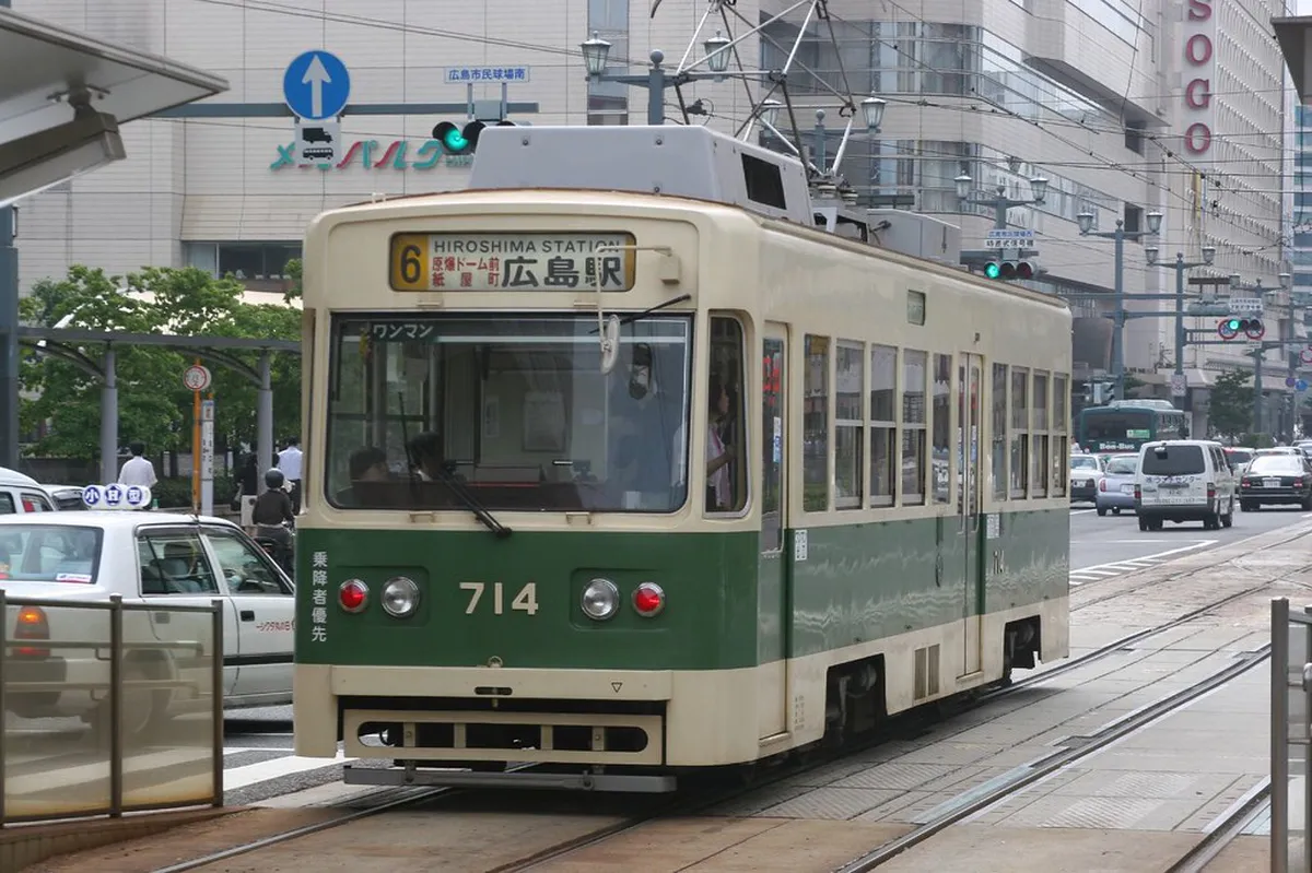 Hiroden streetcar tram running through the city streets of Hiroshima near the Peace Memorial area, Japan