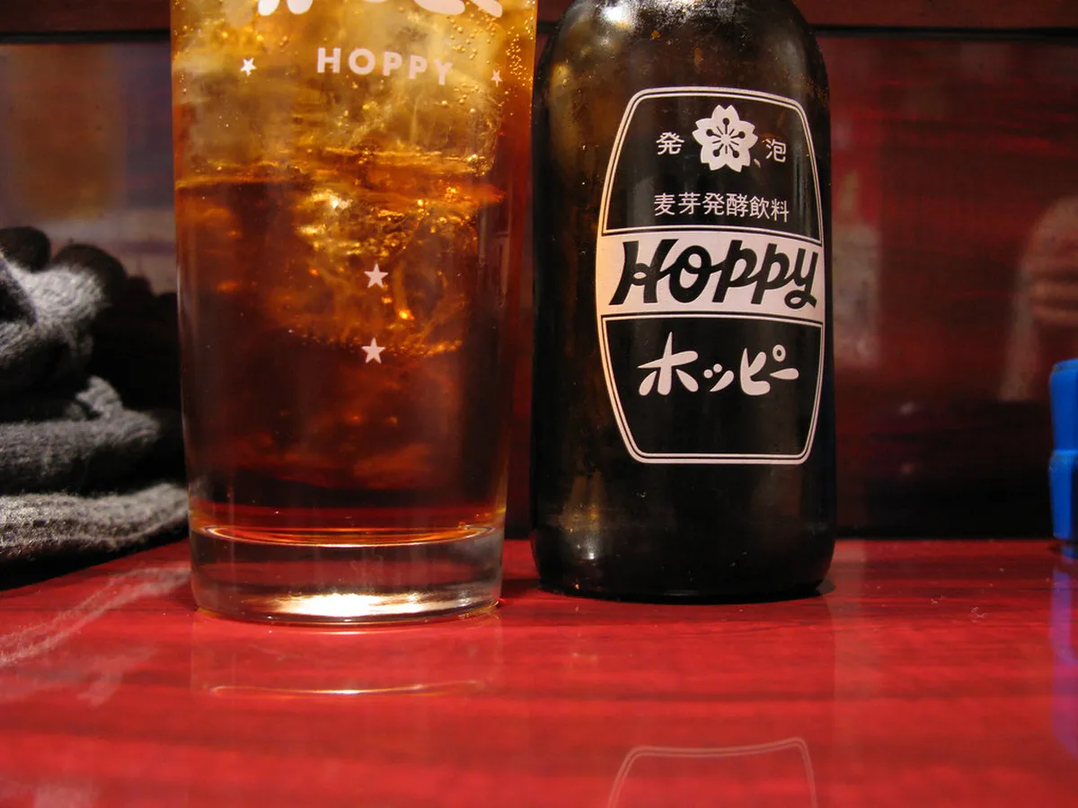 Glass and bottles of imo-jochu sweet potato shochu, the signature spirit of Kagoshima, Japan