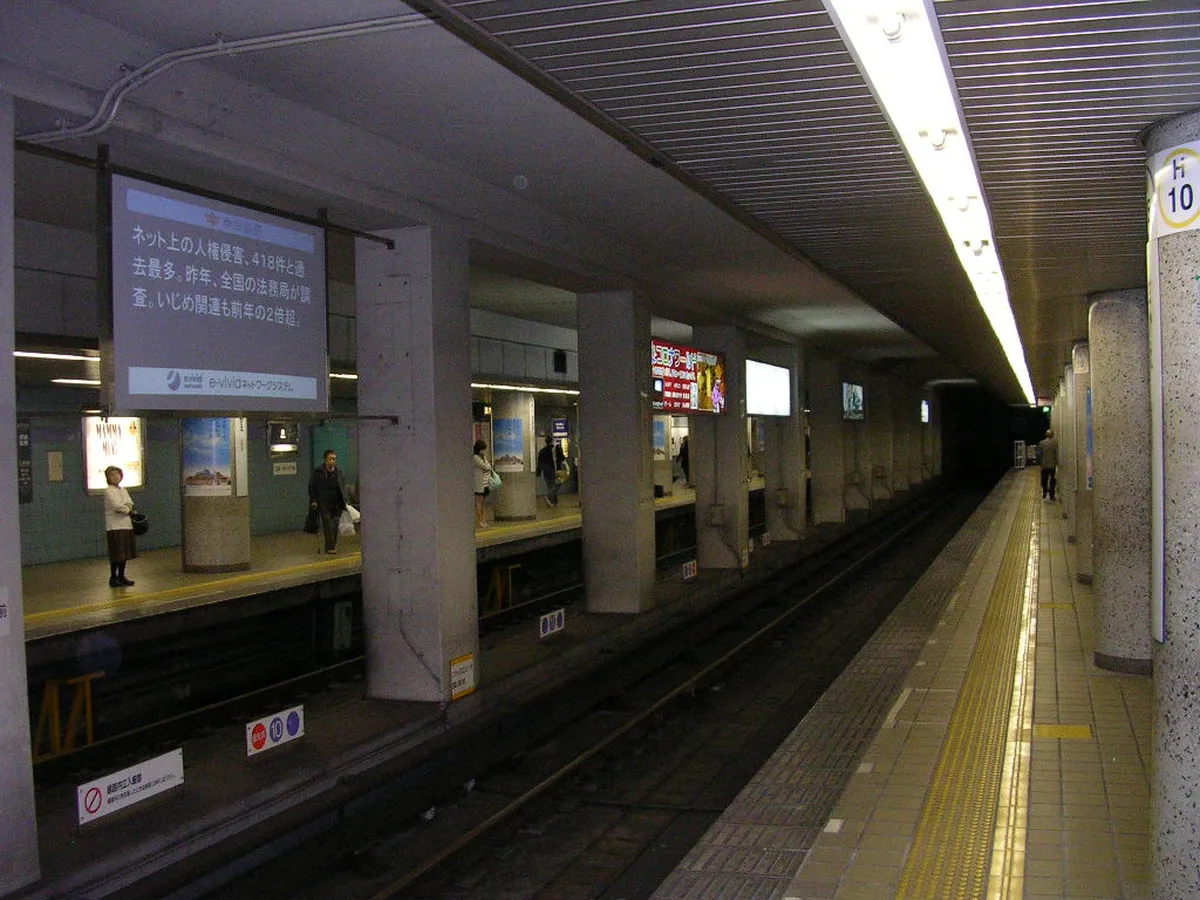 Nagoya subway station platform with color-coded signage, part of the municipal underground network in Nagoya, Japan