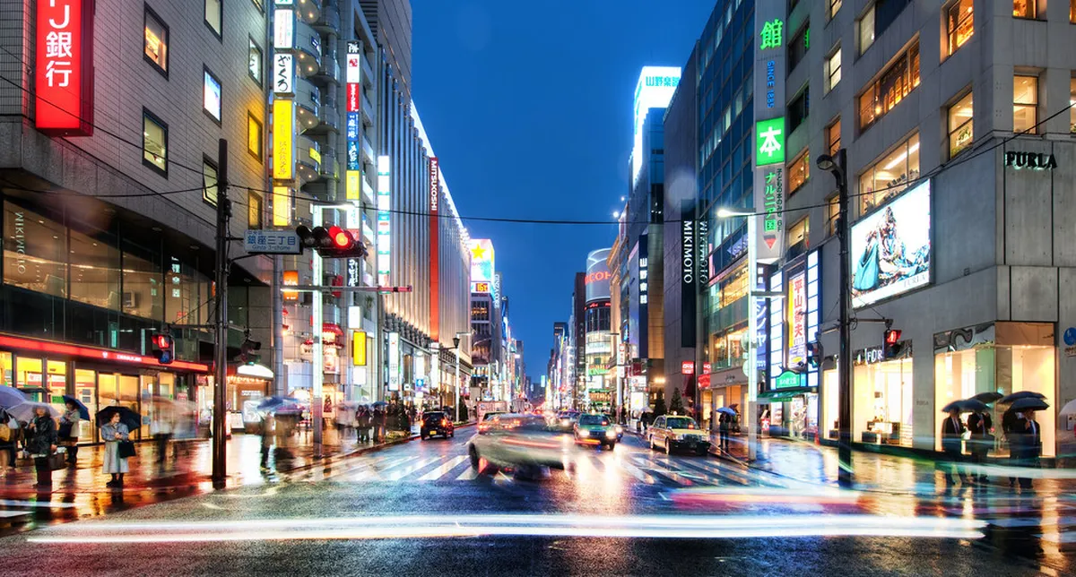 Vibrant Japan nightlife street scene with illuminated signs and bars, evoking the evening atmosphere in Beppu's Kitahama district