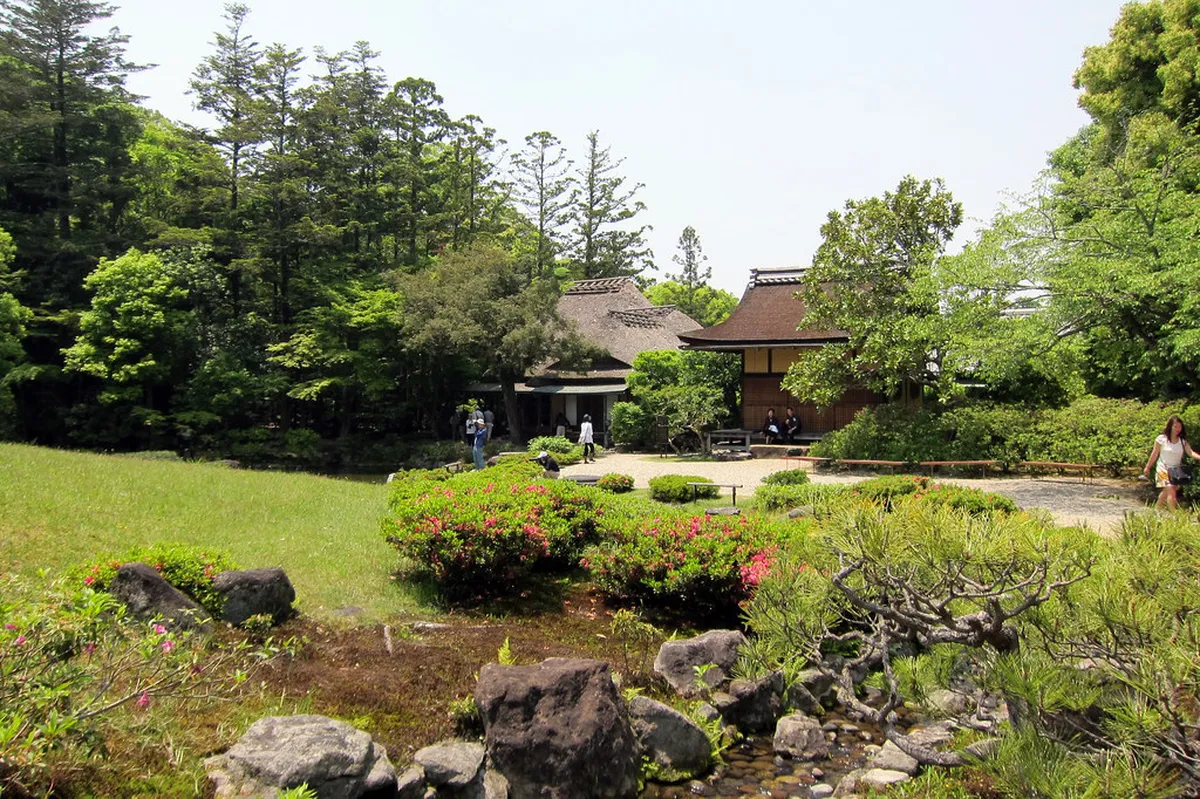 Traditional Japanese garden architecture and tea house at Isuien in Nara, Japan with lush greenery