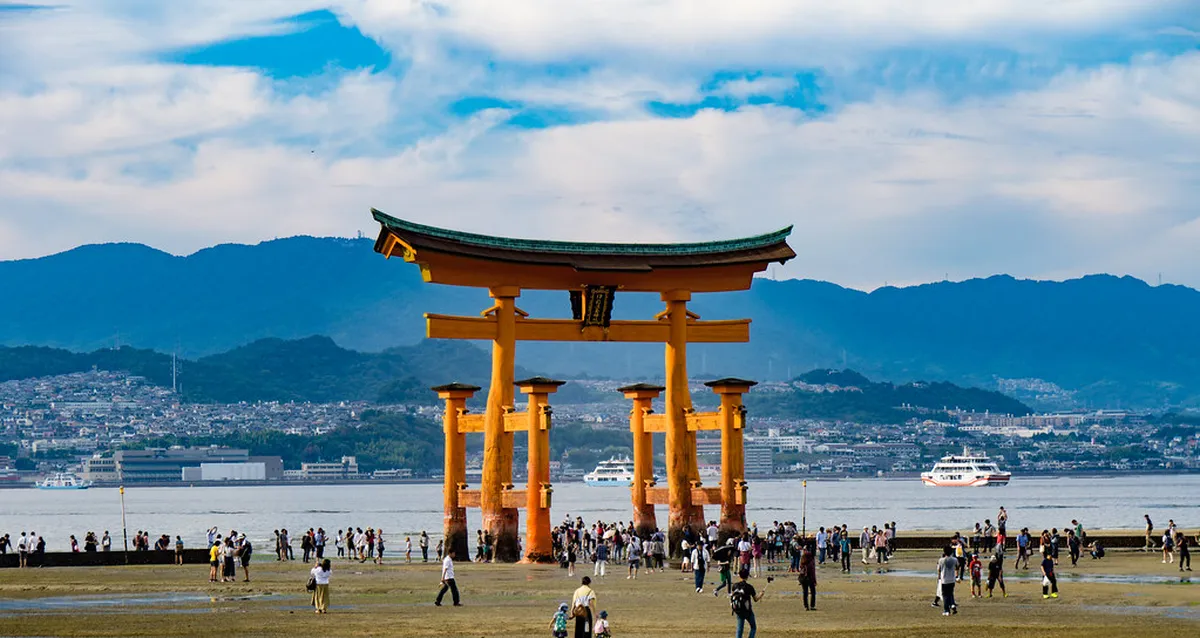 The iconic red torii gate of Itsukushima Shrine appearing to float over the sea at high tide, Miyajima, Japan