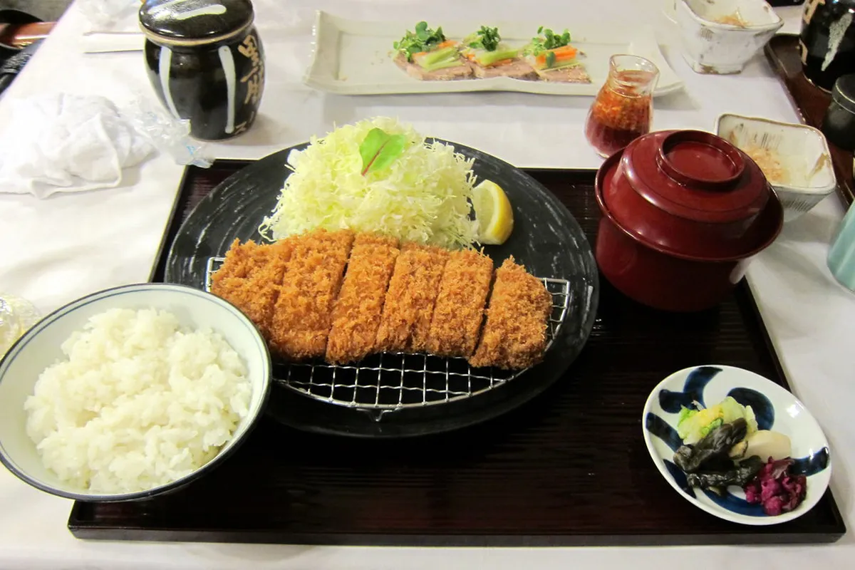 Kurobuta black pork tonkatsu cutlet served with shredded cabbage and miso sauce in Kagoshima, Japan
