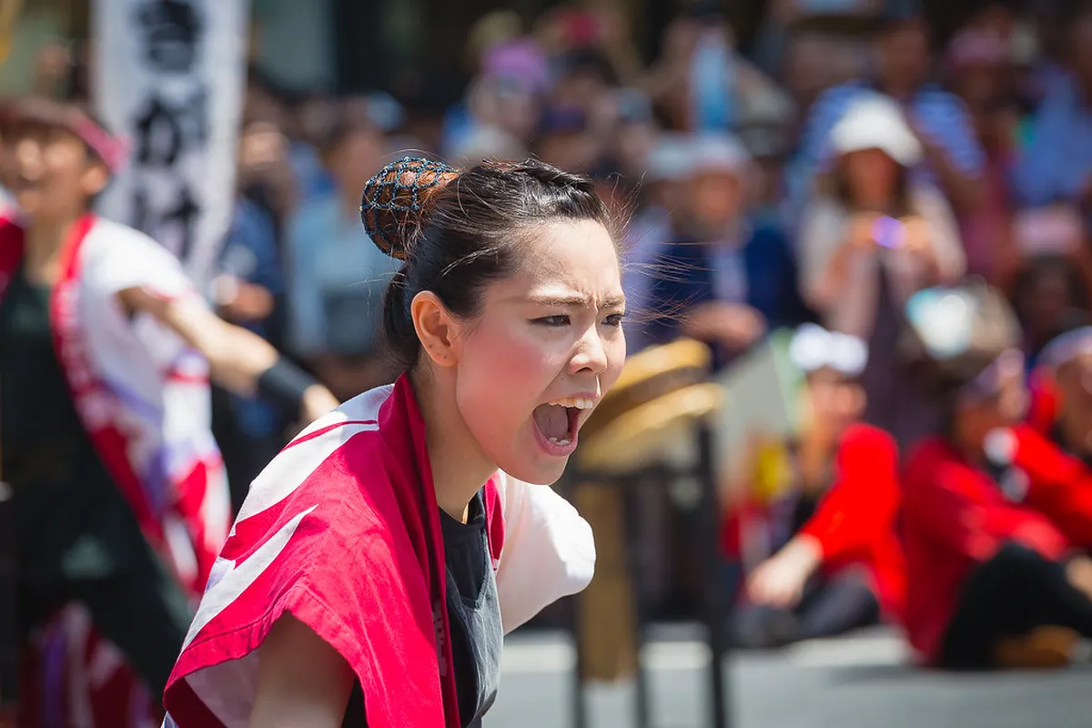 Ohara Festival dancers in traditional costumes performing through the Tenmonkan district in Kagoshima, Japan